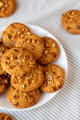 Homemade Cookies with Peanuts on a white plate, side view.