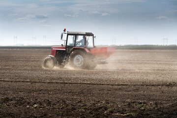 Tractor spreading artificial fertilizers