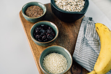 vegetarian set of seeds, sesame, cranberry. composition on a wooden board. Healthy food, healthy bowls with cereals and banana 