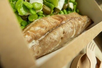 Mackerel with bean side dish, bean puree, lettuce, celery, mini pickles and capers in degradable...