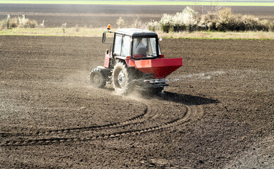 Tractor spreading artificial fertilizers