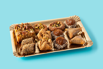 Assortment of Ramadan dessert baklava isolated on blue background