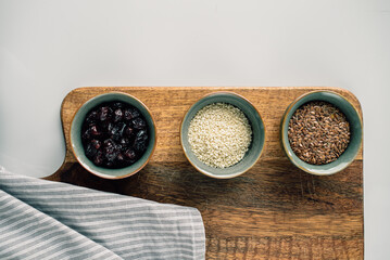 vegetarian set of seeds, sesame, cranberry. composition on a wooden board. Healthy eating,...