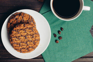 sweet biscuits plates green napkin wooden table coffee