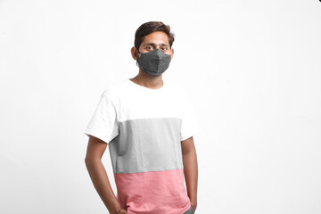 Young asian man in whit t-shirt wearing medical mask on isolated white background. Coronavirus or...