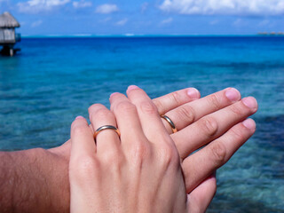 Hands of honeymooners in French Polynesia