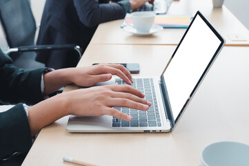Businessman working at a home office uses a close-up keyboard, a man sitting on a wooden table and using a contemporary laptop by the window. Concept of close-up of a hand printed on a laptop.