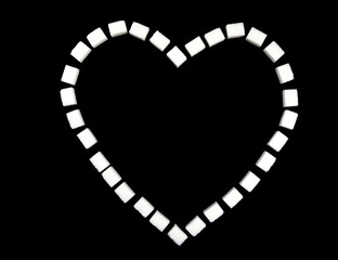 Fototapeta premium Heart lined with sugar cubes on a black background.