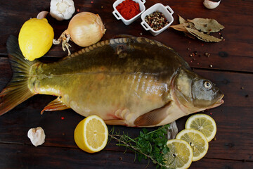 Fresh raw carp fish on wooden background
