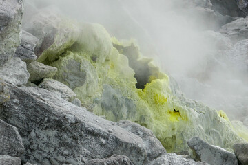 Steam vent inside the crater of Gunung Sibayak volcano with colorful sulfur deposit, near Berastagi, North Sumatra island, Indonesia