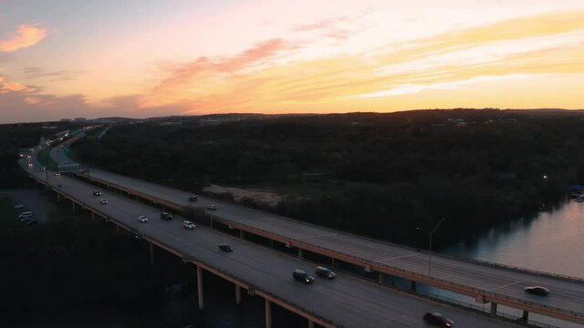 Drivers on Austin, Texas Mopac freeway at sunset driving on bridge over water
