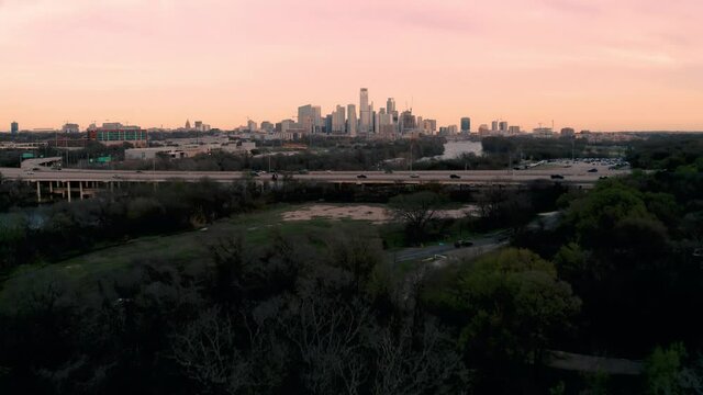 Drone flyover of freeway drivers commuting on Mopac to downtown Austin Texas at sunset
