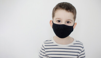 Child boy in black face mask
