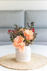 Dried flowers in glass container within a frame