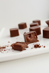 Chocolate candies with ganash on the white plate