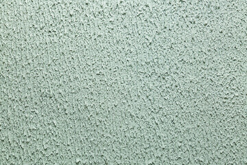 Fototapeta premium Modern pattern of light green decorative plaster.Trendy abstract background. Texture for design and decoration with copy space.