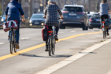 Obraz na płótnie Canvas Leipzig, Saxony, Germany; 03.31.2021 Cyclists on a pop-up cycle path that was newly set up due to the corona pandemic