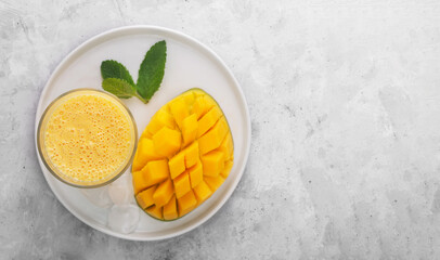 Lassi is a popular traditional yogurt based cold drink with mango in India, flat lay