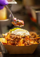 Mexican street fast food with tacos, fajitas and nachos. Chef preparing food in truck