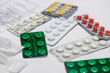 pills in packages of different types on a white background
