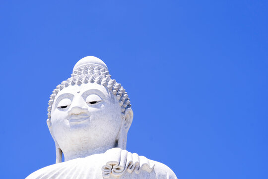 head of  Buddha statue with blue sky.