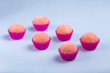 Strawberry brigadeiro covered in sugar, traditional Brazilian sweet.