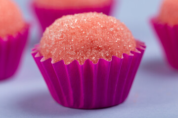 Strawberry brigadeiro covered in sugar, traditional Brazilian sweet.
