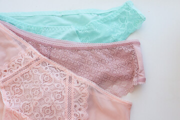women's, lace panties, pink, turquoise, laid out on a light background. Difficulties in choosing...