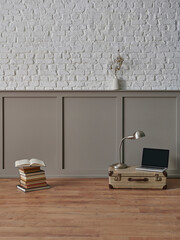 Decorative white brick wall concept with brown classic wall, poster and frame, old suitcase, book and laptop still life concept.