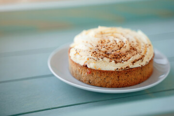 Buttercream and cinnamon cake on a blue tray