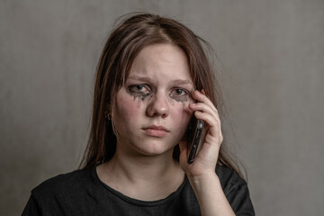 Crying teen girl talking to using a mobile phone