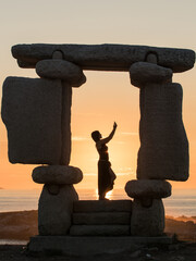 stone statue at sunset