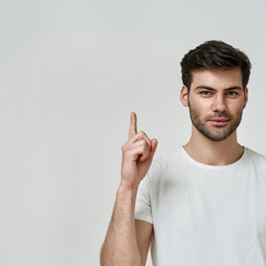 Young bearded man wearing t-shirt raise thumb up