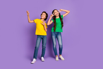 Fototapeta premium Full length photo of boy and girl make v-sign good mood smile best friends isolated on purple color background