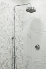 Shower and ceramic tiles in bathroom