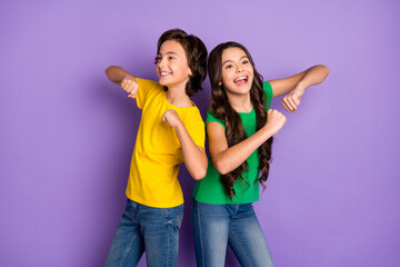 Photo of two trendy brunette cheerful children dance dream funky mood isolated on purple color...