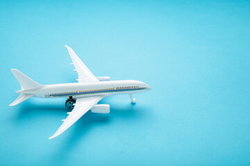 Model airplane on blue pastel color background.