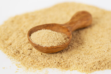 Inactive yeast in a wooden spoon. Healthy food concept. 