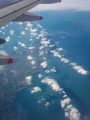 Aerial View of British Coast with Aircraft Wing and Cloud Pattern