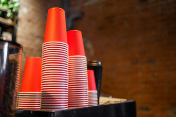 paper, craft red cups on the indoor coffee maker. Fast food concept. Close up.