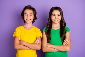 Photo of two preteen kid boy girl happy positive smile confident crossed hands isolated over purple color background