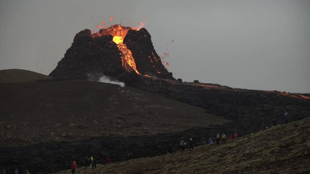 Volcanic eruption Iceland 2021 people next to volcano cone