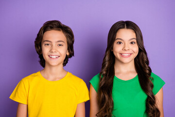 Photo of young cheerful two kids girl boy friends happy positive smile isolated over violet color background