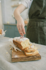 Women's hands sprinkle Easter bread with flour. Easter bread. 