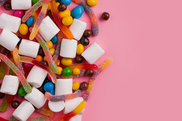 Lots of sweets on a pink background. Copy space. view from above