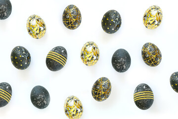 Black easter eggs with gold pattern on white