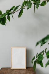 light wooden frame for photography in the interior with a plant 