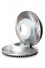Naklejka premium Perforated brake pads next to brake disc on white background isolated object