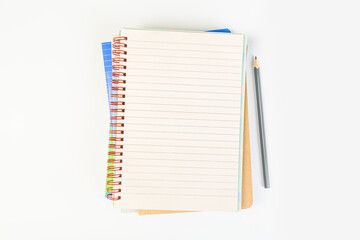 top view of an open notebook with a pencil on a gray background, school notebooks with a spiral spring, office notepad. desktop concept, learning