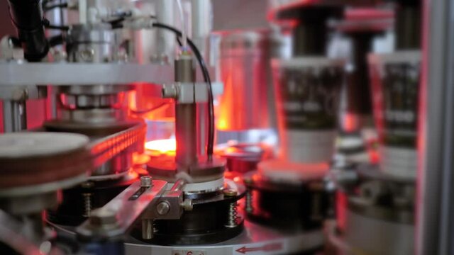 Fully automatic high speed disposal paper cup making machine for manufacturing coffee cups. at package exhibition, trade show - close up view. Industrial, equipment, technology concept